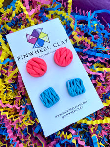 Beautiful polymer clay stud earrings set in hot pink and blue, inspired by the intricate art of knitting