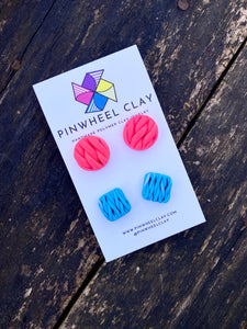 Beautiful polymer clay stud earrings set in hot pink and blue, inspired by the intricate art of knitting
